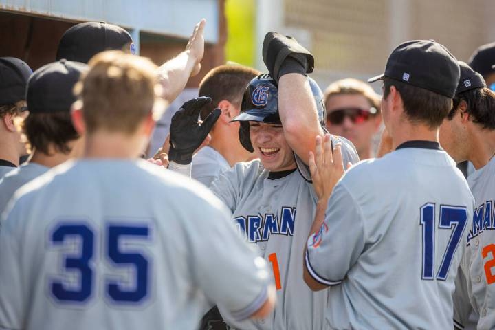 Bishop Gorman batter Andrew Israel (1) is celebrated after scoring during the seventh inning of ...