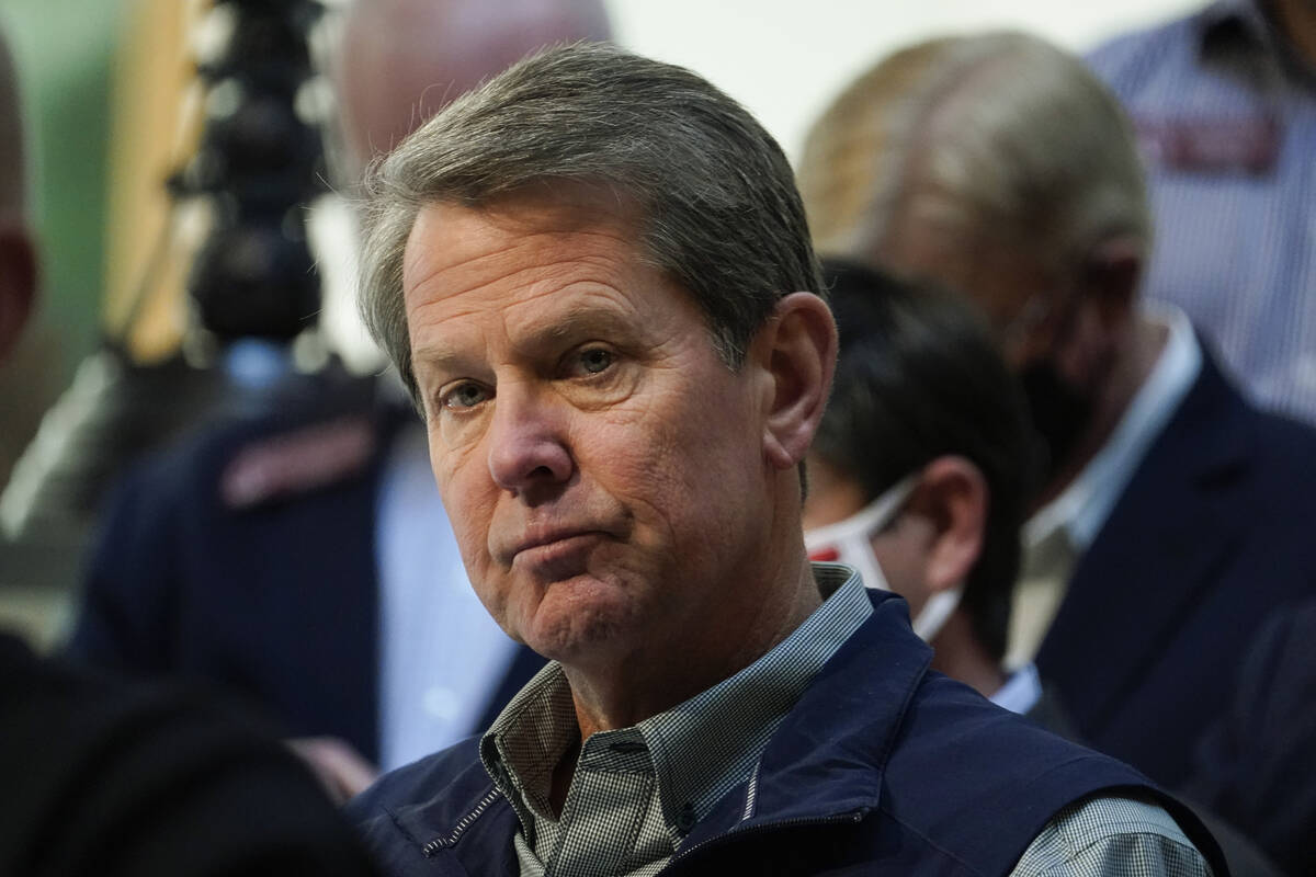 FILE - Georgia Gov. Brian Kemp listens to a question during a news conference at the State Capi ...
