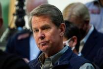 FILE - Georgia Gov. Brian Kemp listens to a question during a news conference at the State Capi ...