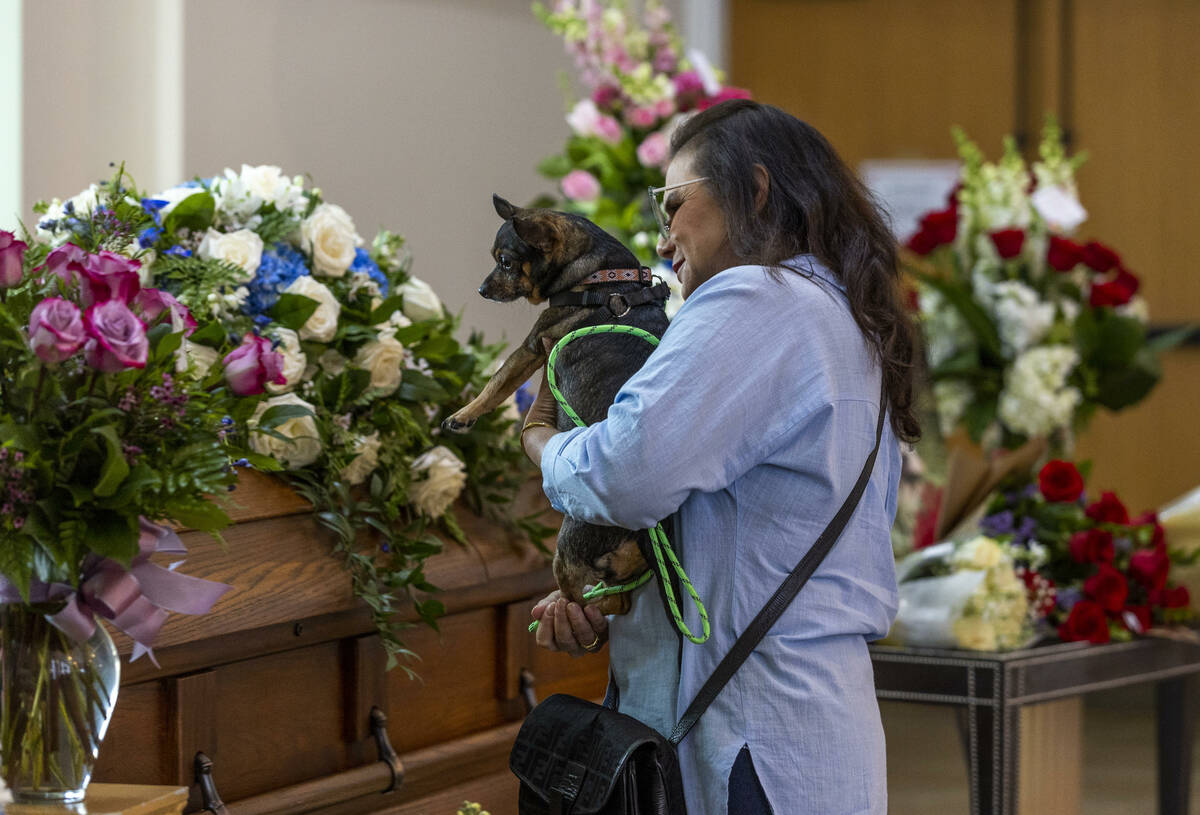 Tabatha Tozzi's dog Lulu looks to her casket during her funeral service at Palms Northwest Mort ...