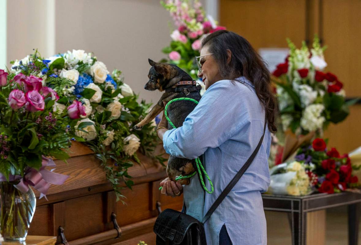 Tabatha Tozzi's dog Lulu looks to her casket during her funeral service at Palms Northwest Mort ...