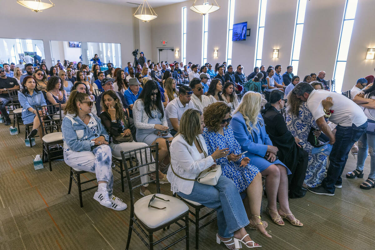 Mom Regina Lacerda, right, is comforted before a packed room of mourners during a funeral for h ...