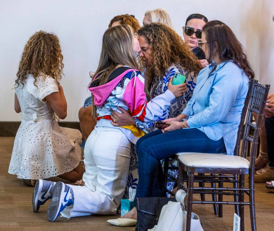 Mom Regina Lacerda, center, is comforted by her niece Karina Brelaz, left, during a funeral for ...