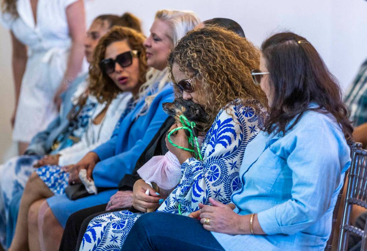 Mom Regina Lacerda kisses her daughter's dog Lulu during a funeral for her at Palms Northwest M ...