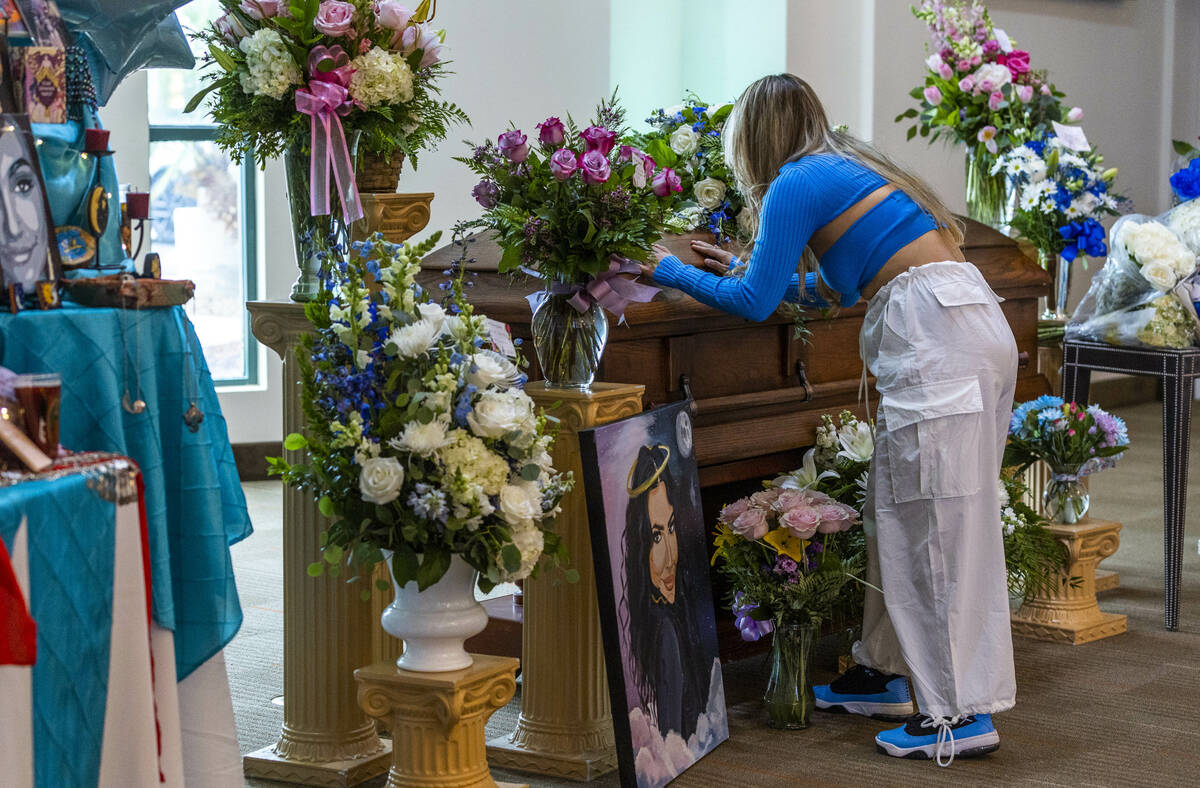 A mourner says goodbye during a funeral service for Tabatha Tozzi at Palms Northwest Mortuary o ...