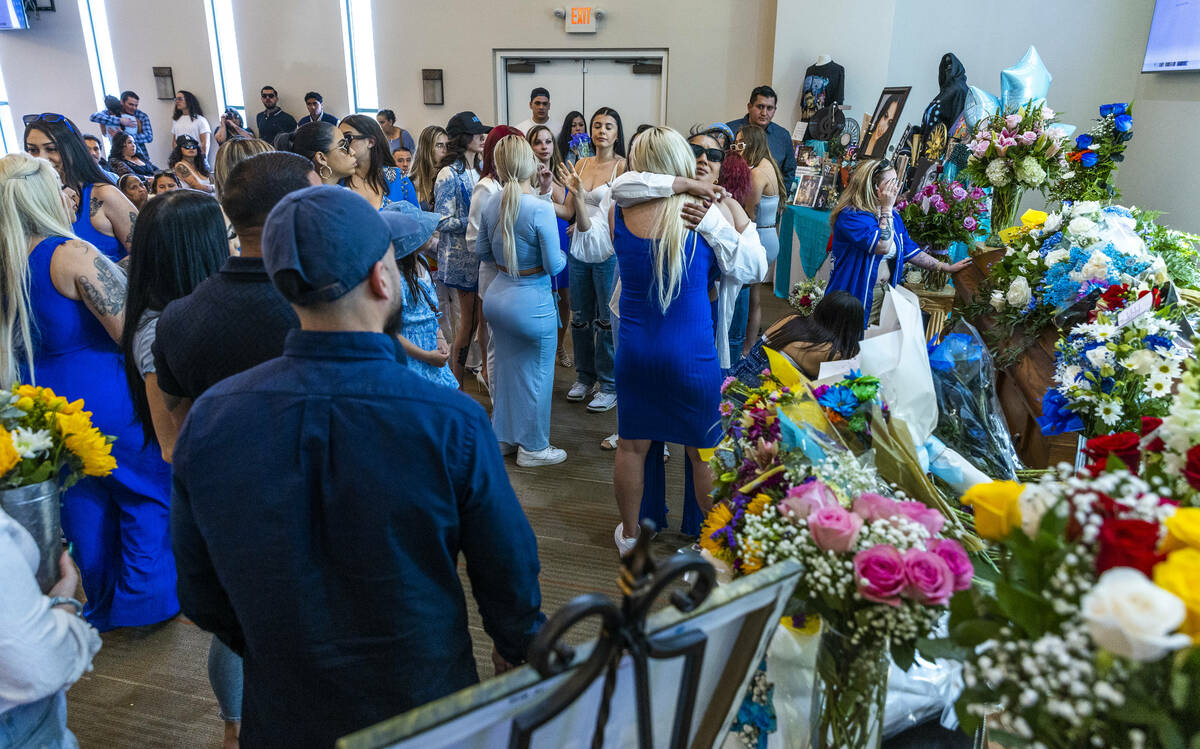 Mourners comfort each other and say their final goodbyes during a funeral service for Tabatha T ...