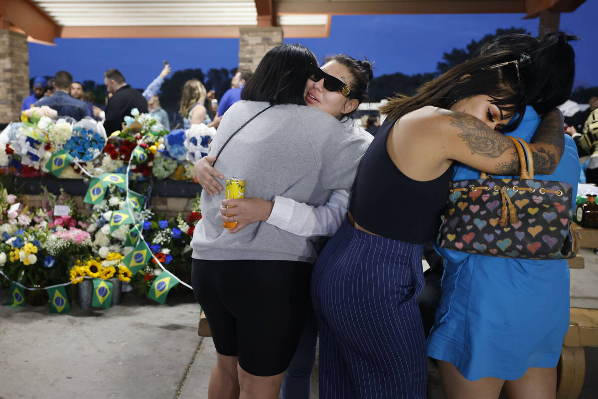 Tabatha Tozzi’s friends, Asia Heaivilin, second from right, hugs Melissa Lopez, right, b ...