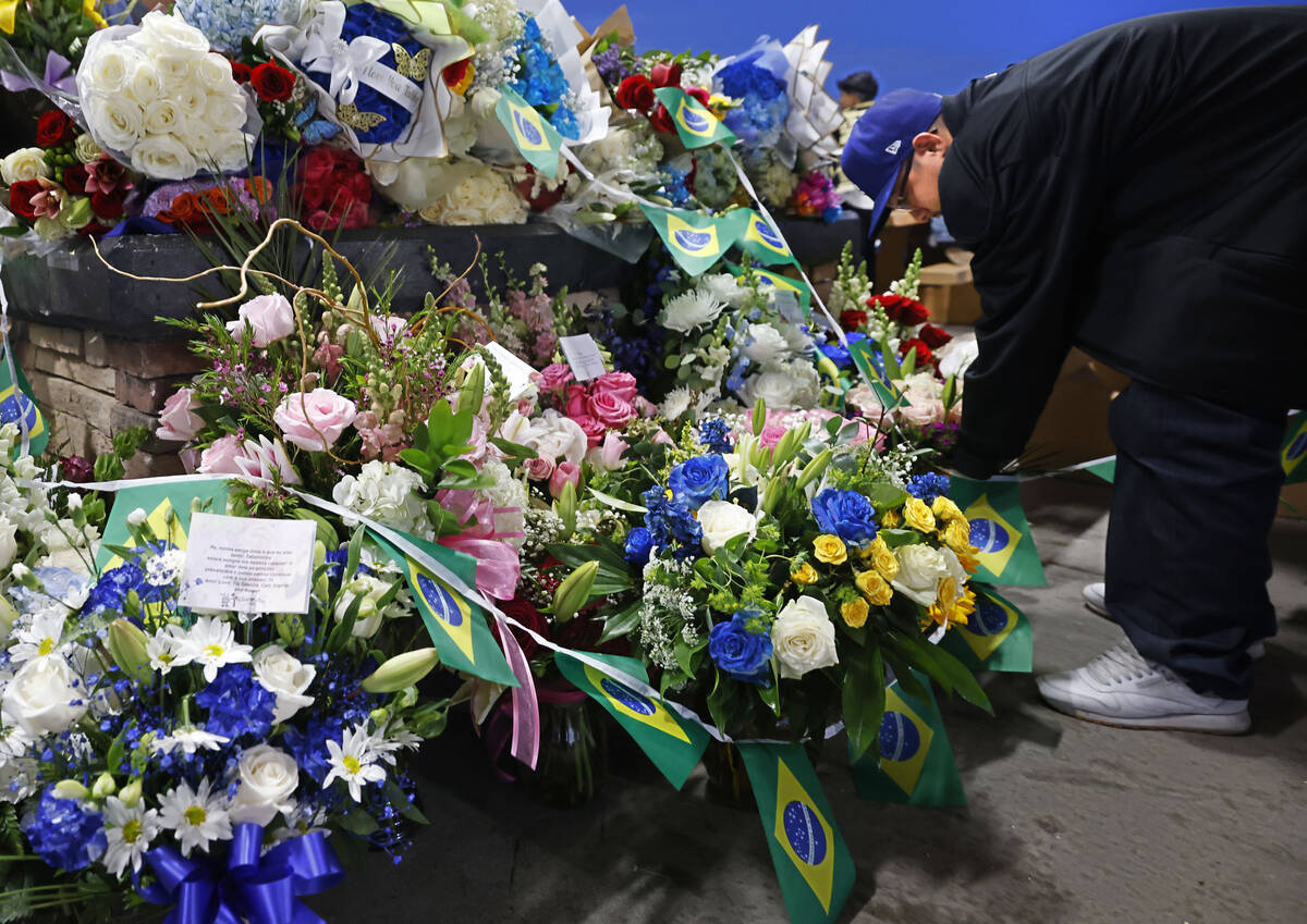 Tabatha Tozzi’s friend Levi Martinez of of Las Vegas places flowers during a vigil for T ...
