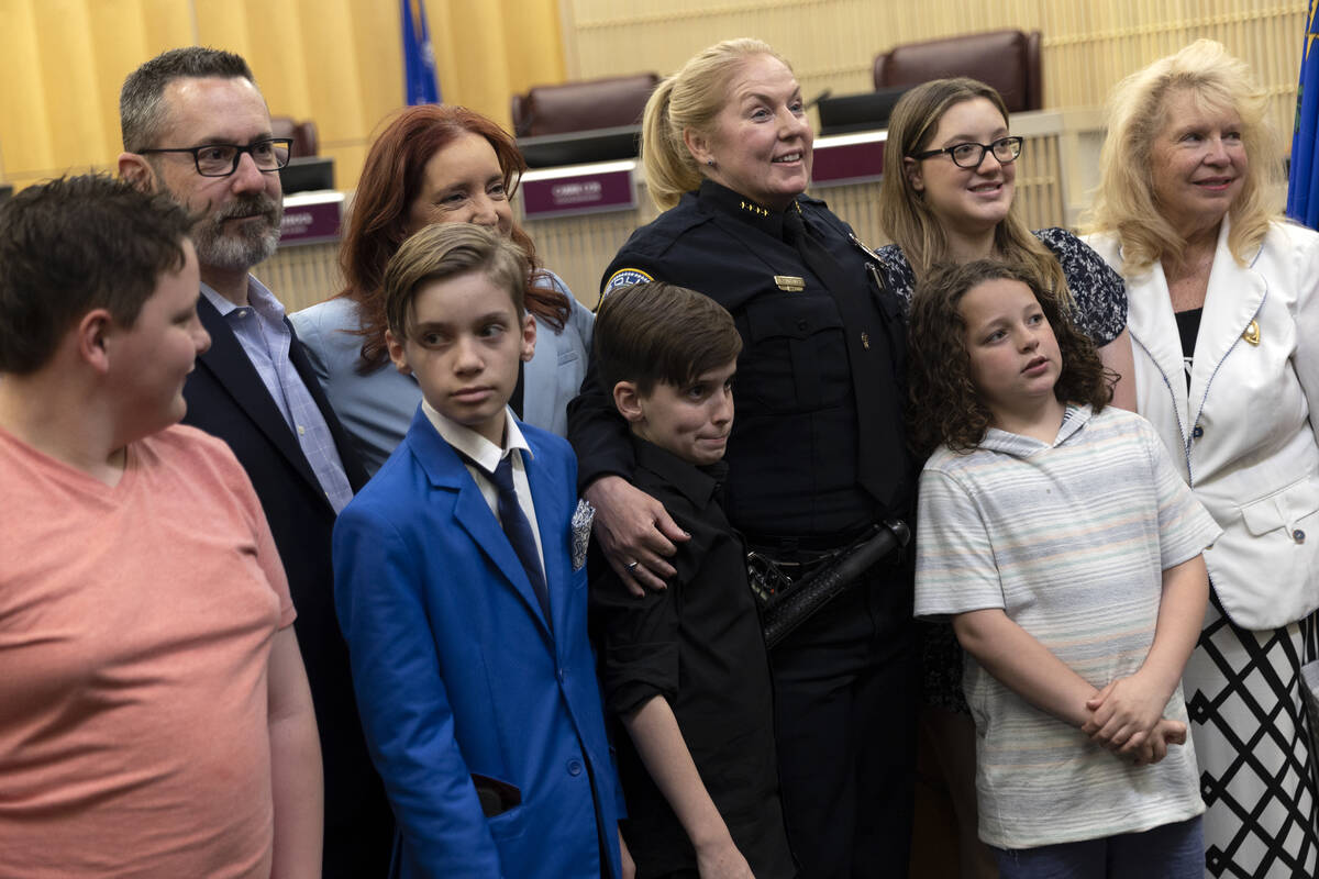 Police chief Hollie Chadwick poses for photos with her family after her swearing-in ceremony at ...