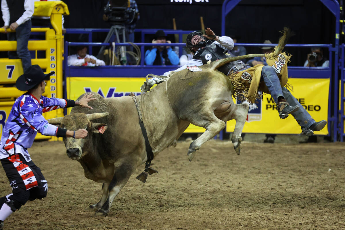 Trevor Kastner competes in the bull riding event during round 10 of the 64th Wrangler National ...