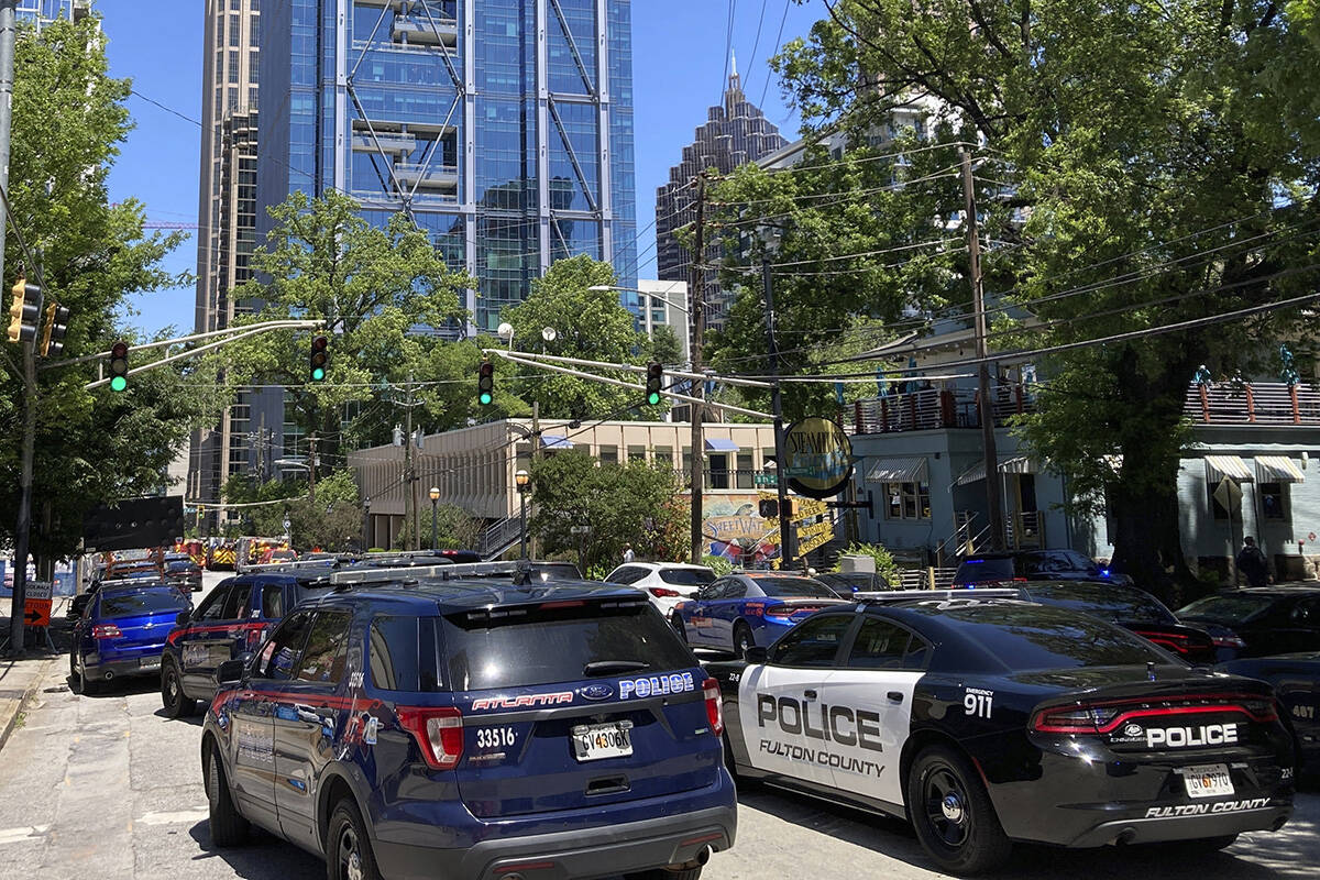 Emergency vehicles arrive on West Peachtree in Atlanta on Wednesday, May 3, 2023. Police say a ...
