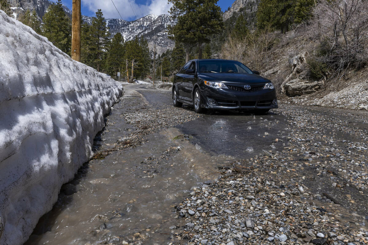 Snowmelt and smaller rocks cover parts of Echo Road within Kyle Canyon on Mount Charleston on A ...