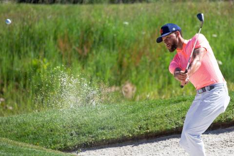 Stephen Curry watches a shot from a bunker on the first hole during the first round of the Amer ...