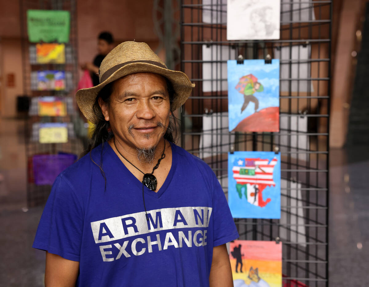 Visiting Mexican artist Olegario Hernández Mendoza stands at an art exhibit showing his work a ...
