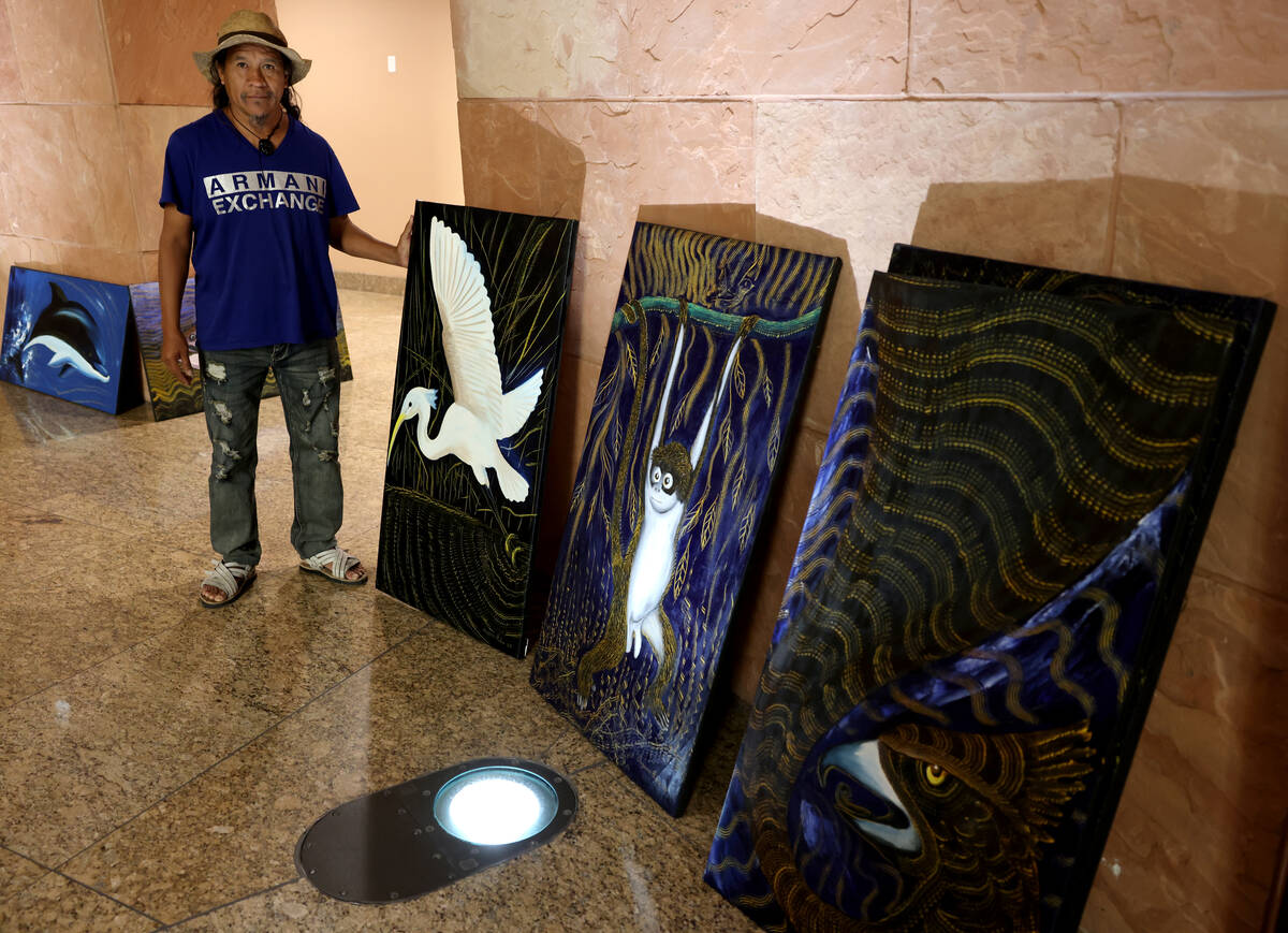 Visiting Mexican artist Olegario Hernández Mendoza stands with some of his art in the rotunda ...