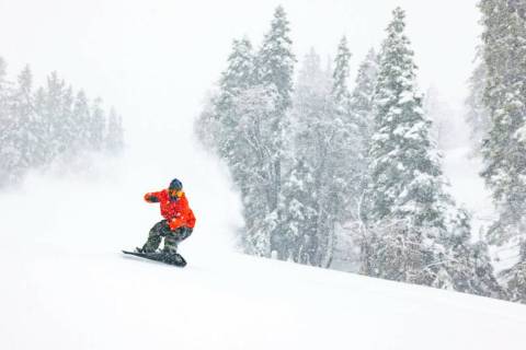 A snowboarder slides in Big Bear Mountain Ski resort in Big Bear Lake, Calif., Sunday, Jan. 15, ...
