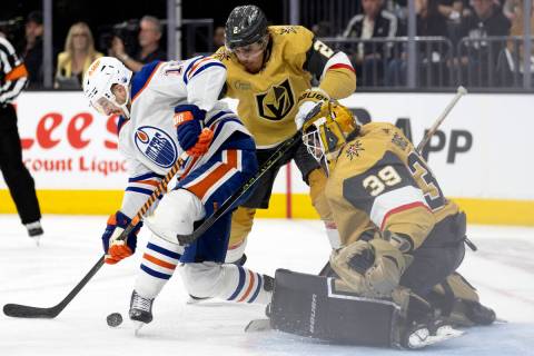 Edmonton Oilers left wing Zach Hyman (18) battles at the net with Golden Knights defenseman Zac ...