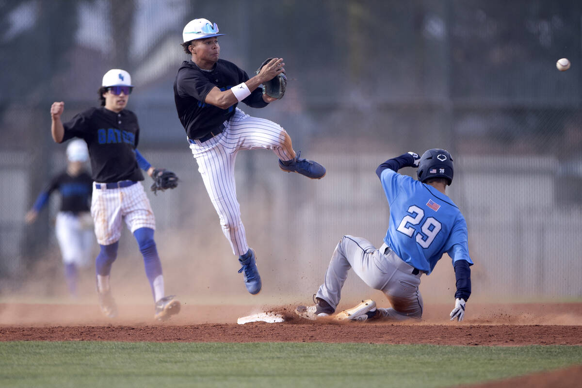 Green Valley’s Caden Kirby, center, jumps to throw to first base after outing Centennial ...