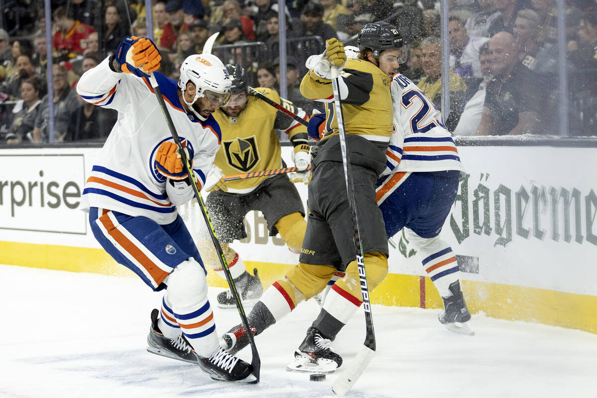 Golden Knights center Brett Howden (21) and left wing William Carrier, behind, fight for posses ...