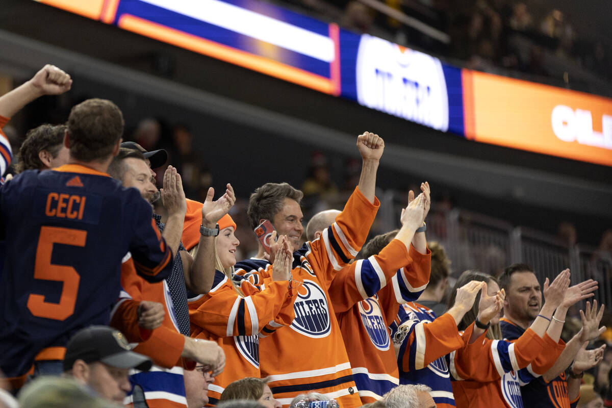 Edmonton Oilers fans celebrate after their team’s fourth goal during the first period in ...