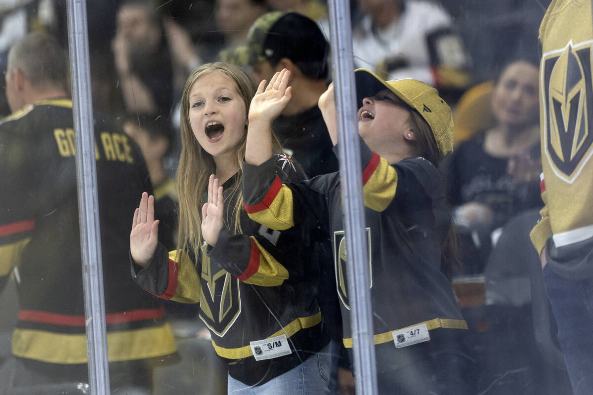 Young Golden Knights fans cheer for their team during the second period in Game 2 of an NHL hoc ...