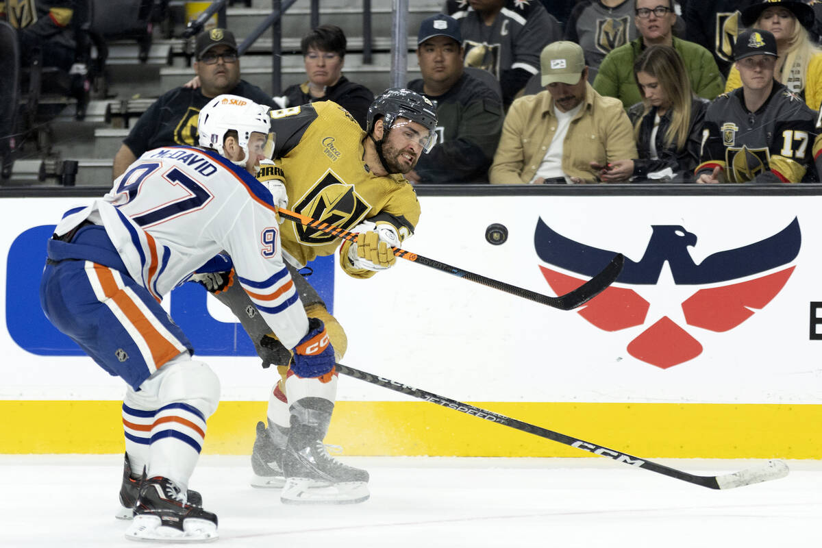 Golden Knights left wing William Carrier (28) shoots while Edmonton Oilers center Connor McDavi ...