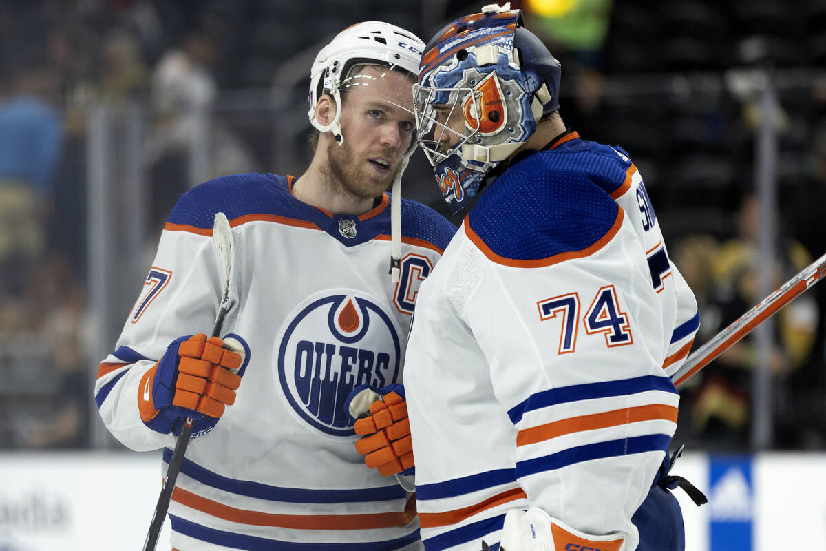 Edmonton Oilers center Connor McDavid (97) congratulates goaltender Stuart Skinner (74) on thei ...