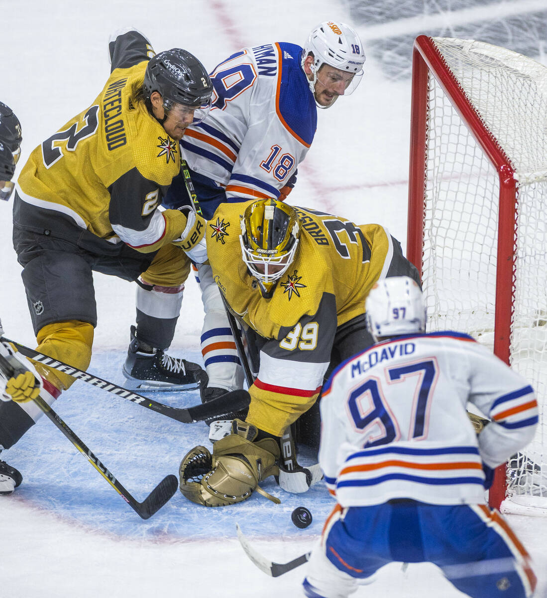 Golden Knights goaltender Laurent Brossoit (39) eyes a loose puck against Edmonton Oilers cente ...