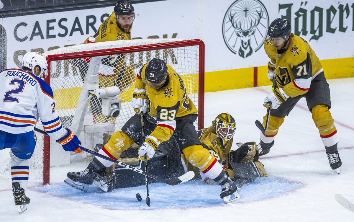 Golden Knights defenseman Alec Martinez (23) attempts to clear a puck shot on goal by Edmonton ...