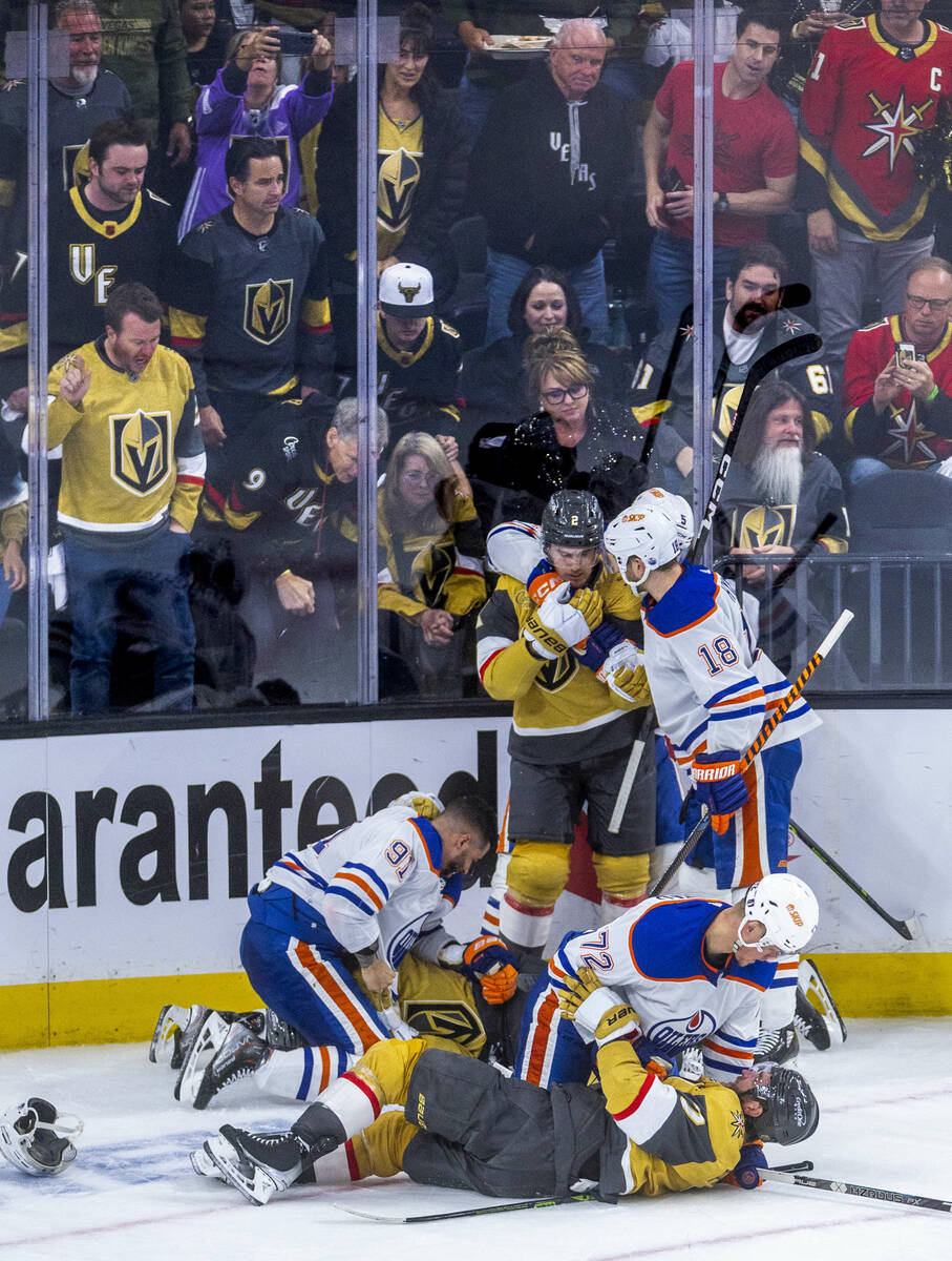 Golden Knights and Edmonton Oilers players fight on the ice during the second period in Game 2 ...