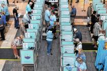 People cast their votes at the polling place inside of the Galleria at Sunset shopping mall in ...