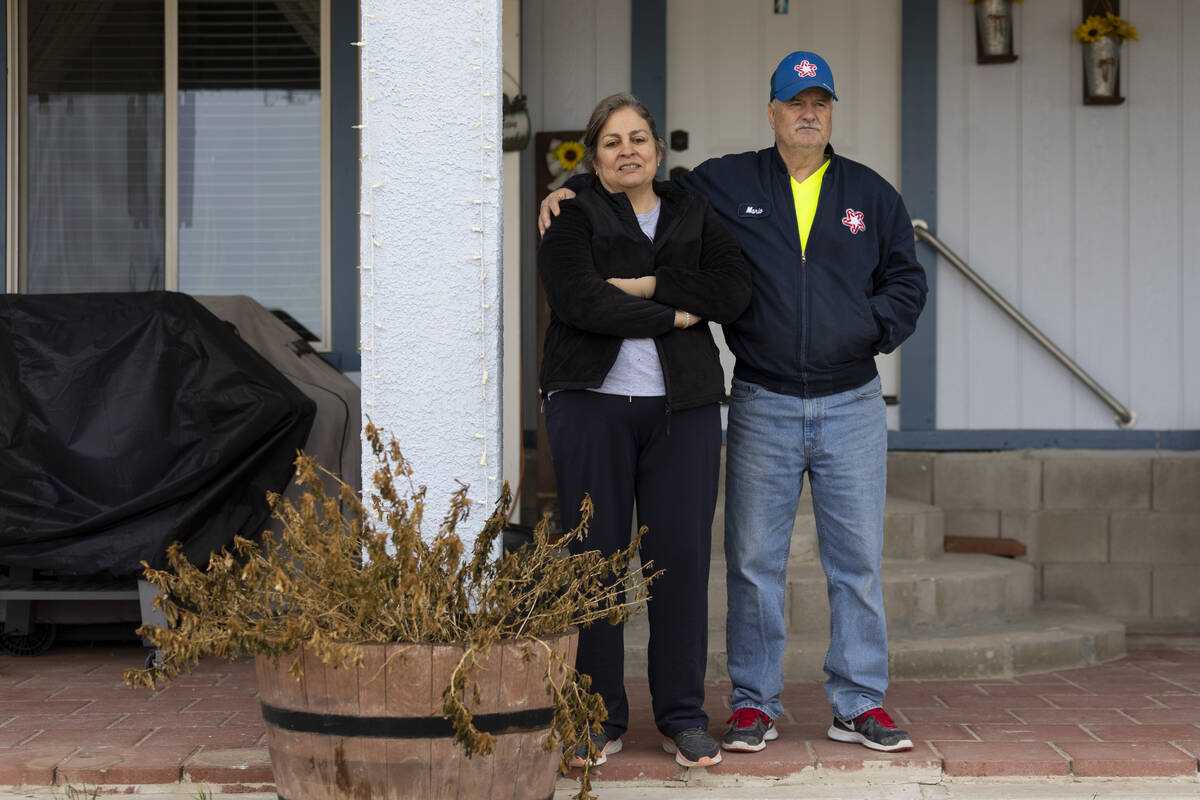 Alma Perez, left, with her husband, Mario, stand outside their home in the Lytle Ranch neighbor ...
