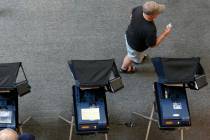 A Henderson resident walks away from a polling station after early election day voting for the ...