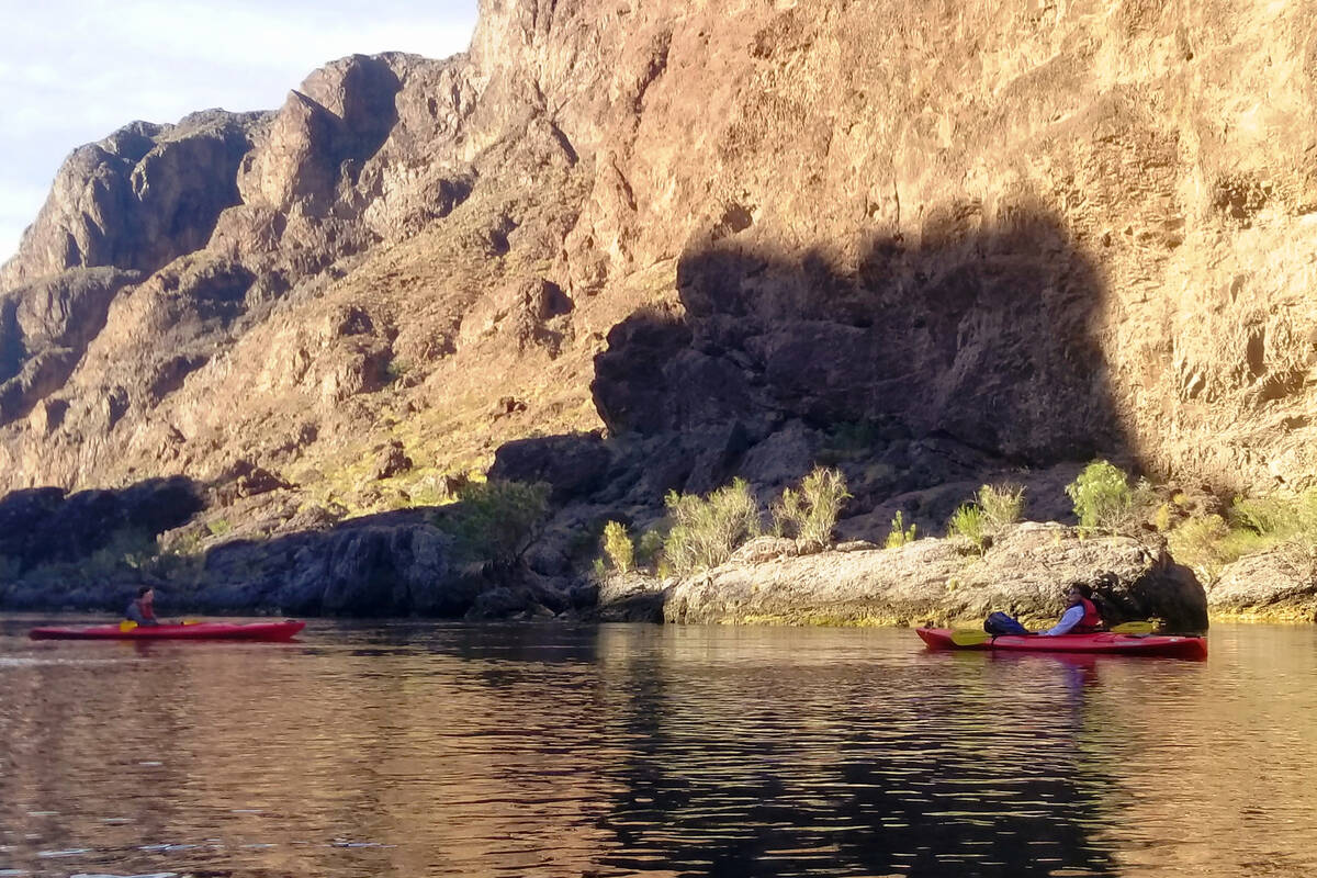 Kayakers paddle in the early morning shadows along the Black Canyon National Water Trail. (Nata ...