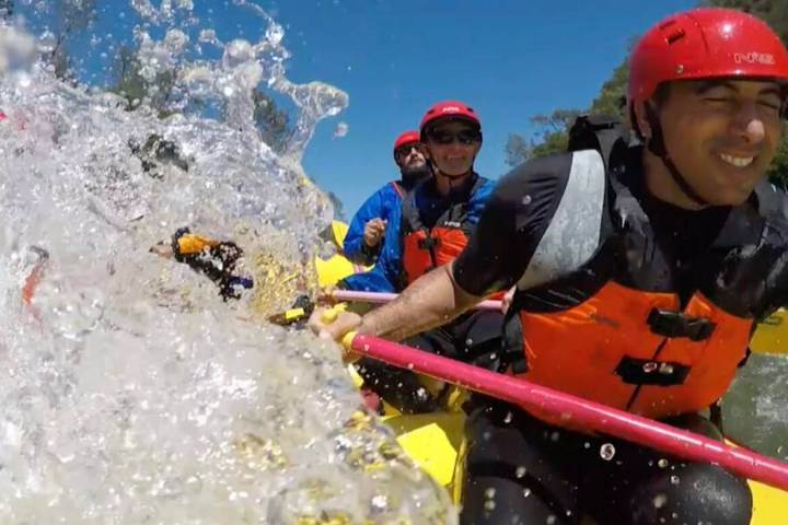 Rowers get splashed during a whitewater rafting trip down the South Fork of the American River ...