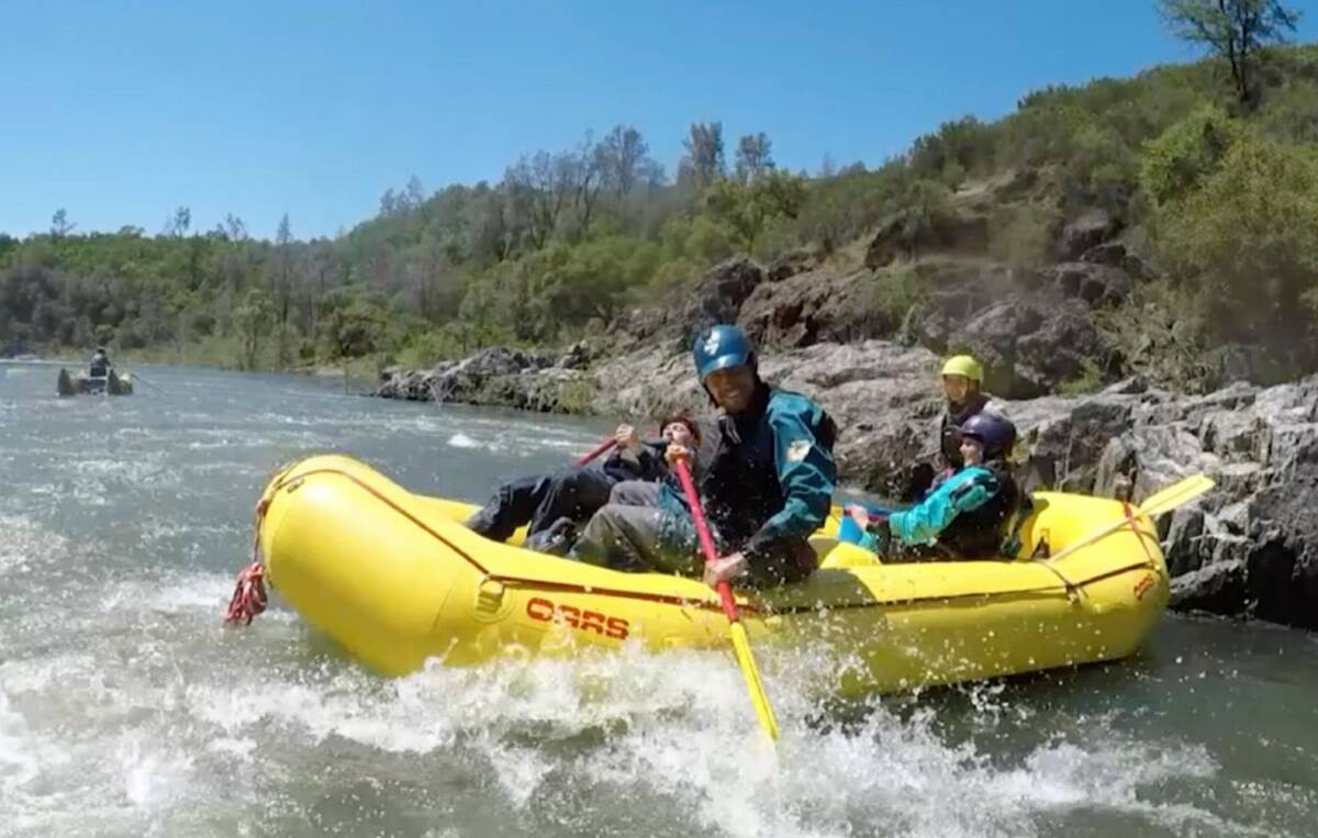 Rowers get splashed during a whitewater rafting trip down the South Fork of the American River ...