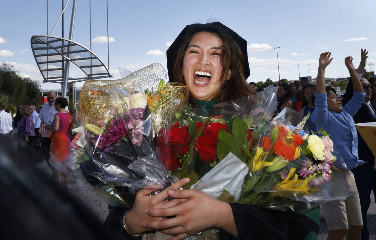 Monica Celine Layson Fortich smiles for a photo after the commencement and academic hooding cer ...