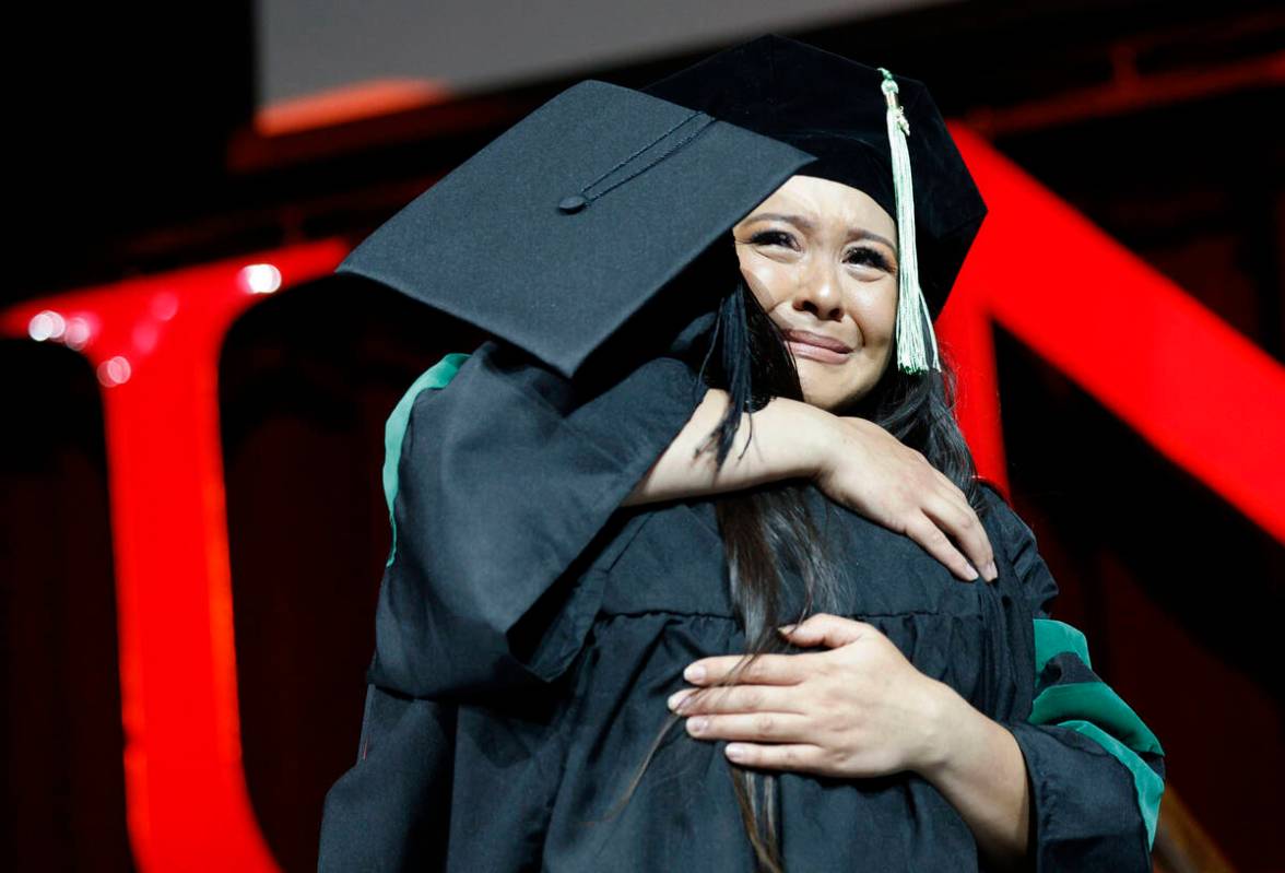 Ashley Crystal Davitt receives a hug from her mother Corrina Davitt after she was hooded by Cor ...