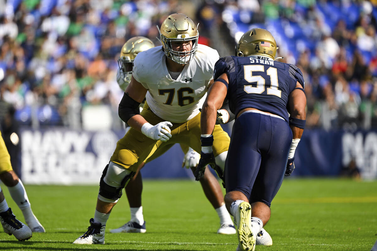 Notre Dame offensive lineman Joe Alt (76) in action against Navy linebacker Nicholas Straw (51) ...