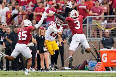 Southern California quarterback Caleb Williams (13) throws a pass as Stanford linebackers Ricky ...