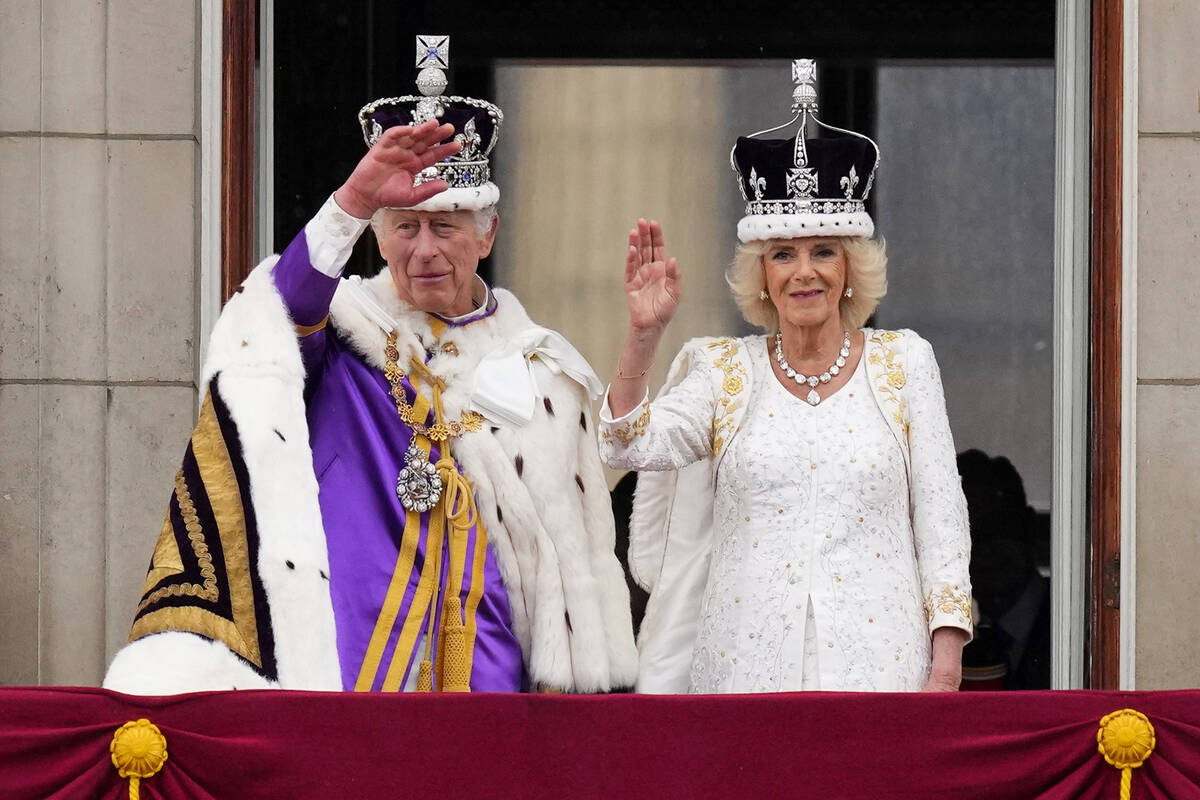 Britain's King Charles III and Queen Camilla wave to the crowds from the balcony of Buckingham ...
