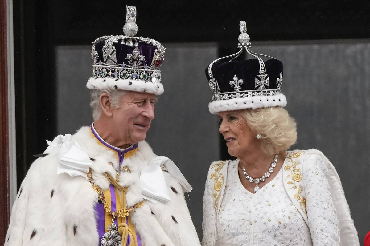 Britain's King Charles III and Queen Camilla talk on the balcony of Buckingham Palace after the ...