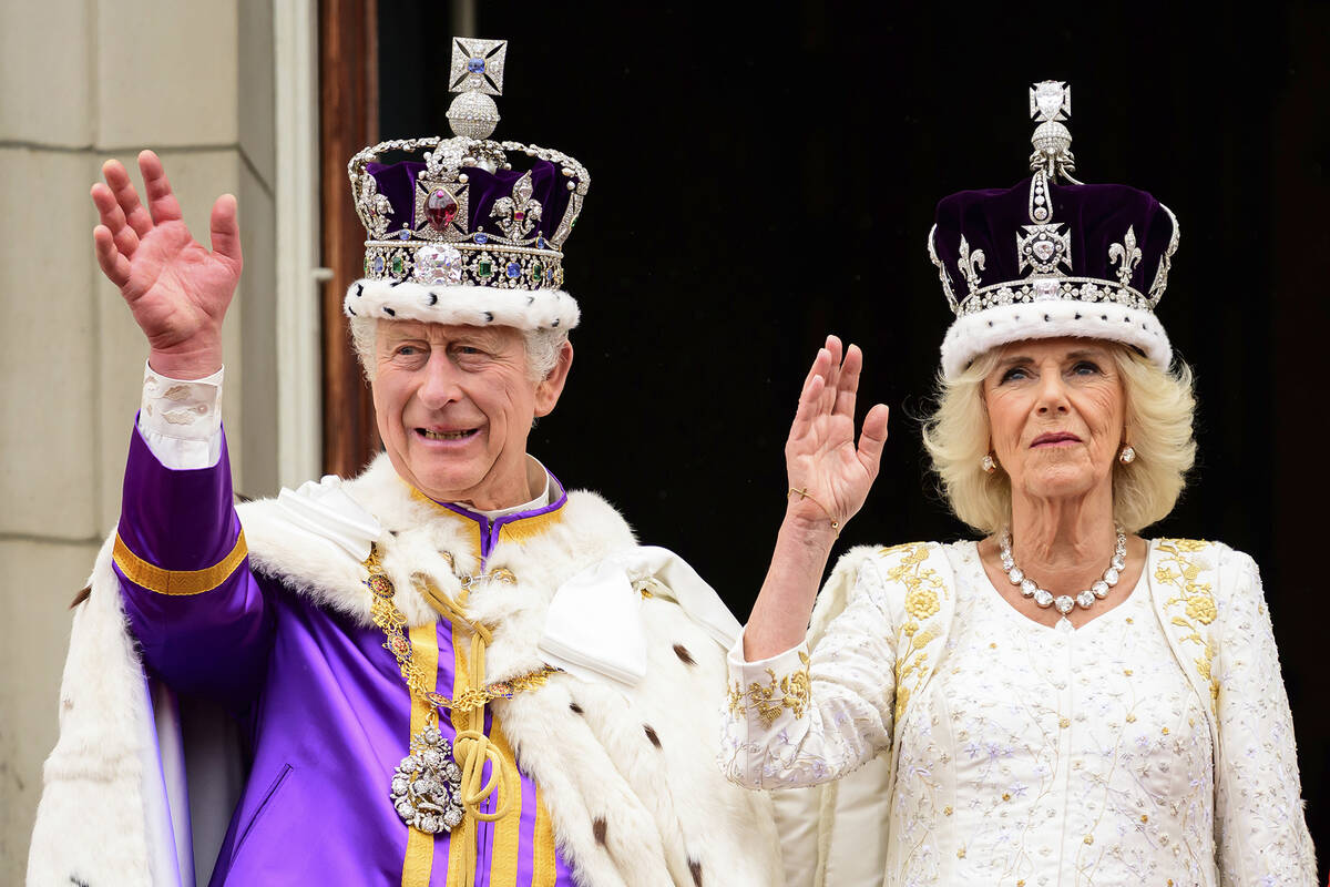 Britain's King Charles III and Queen Camilla wave to the crowds from the balcony of the Bucking ...