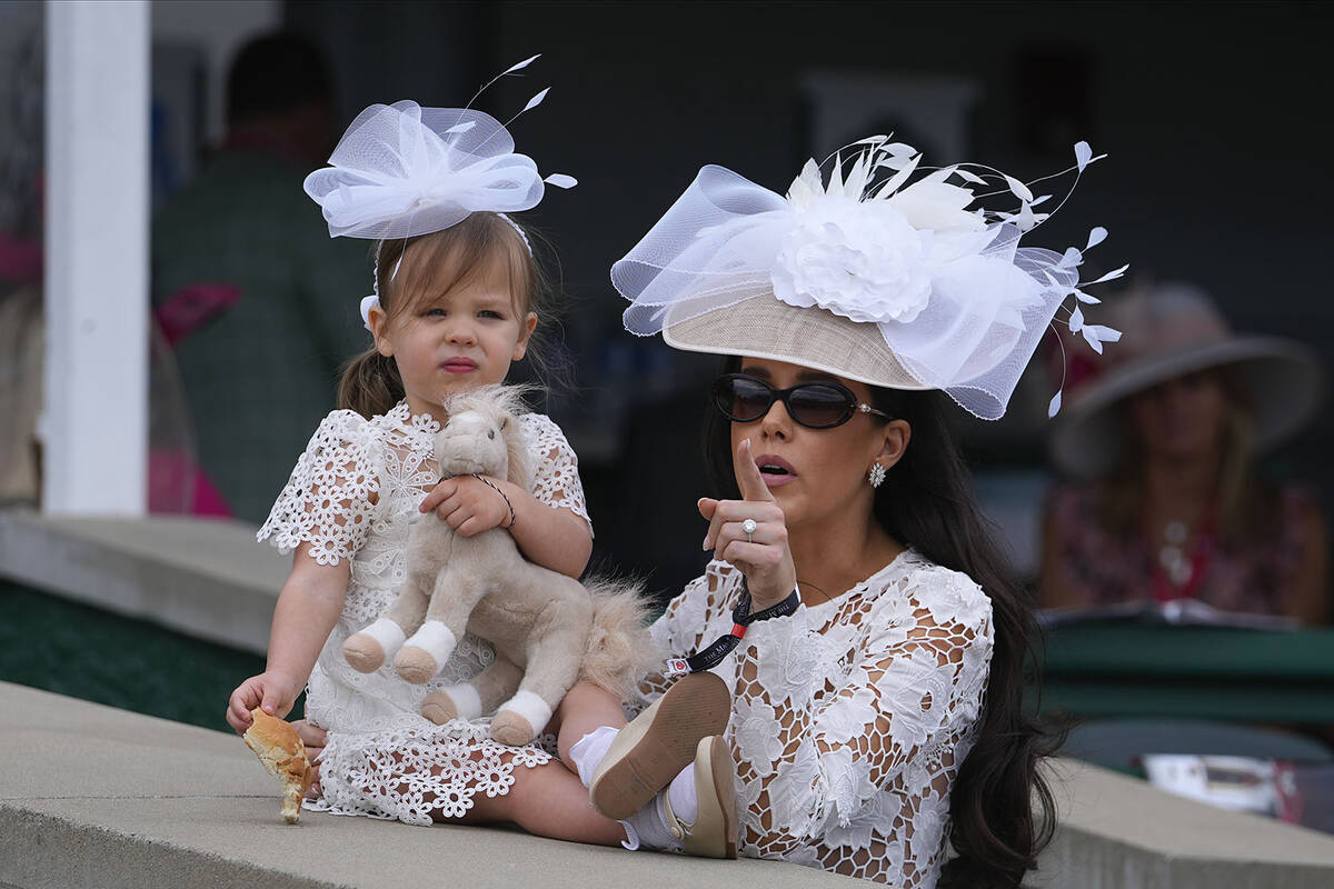 People wait before the 149th running of the Kentucky Derby horse race at Churchill Downs Saturd ...
