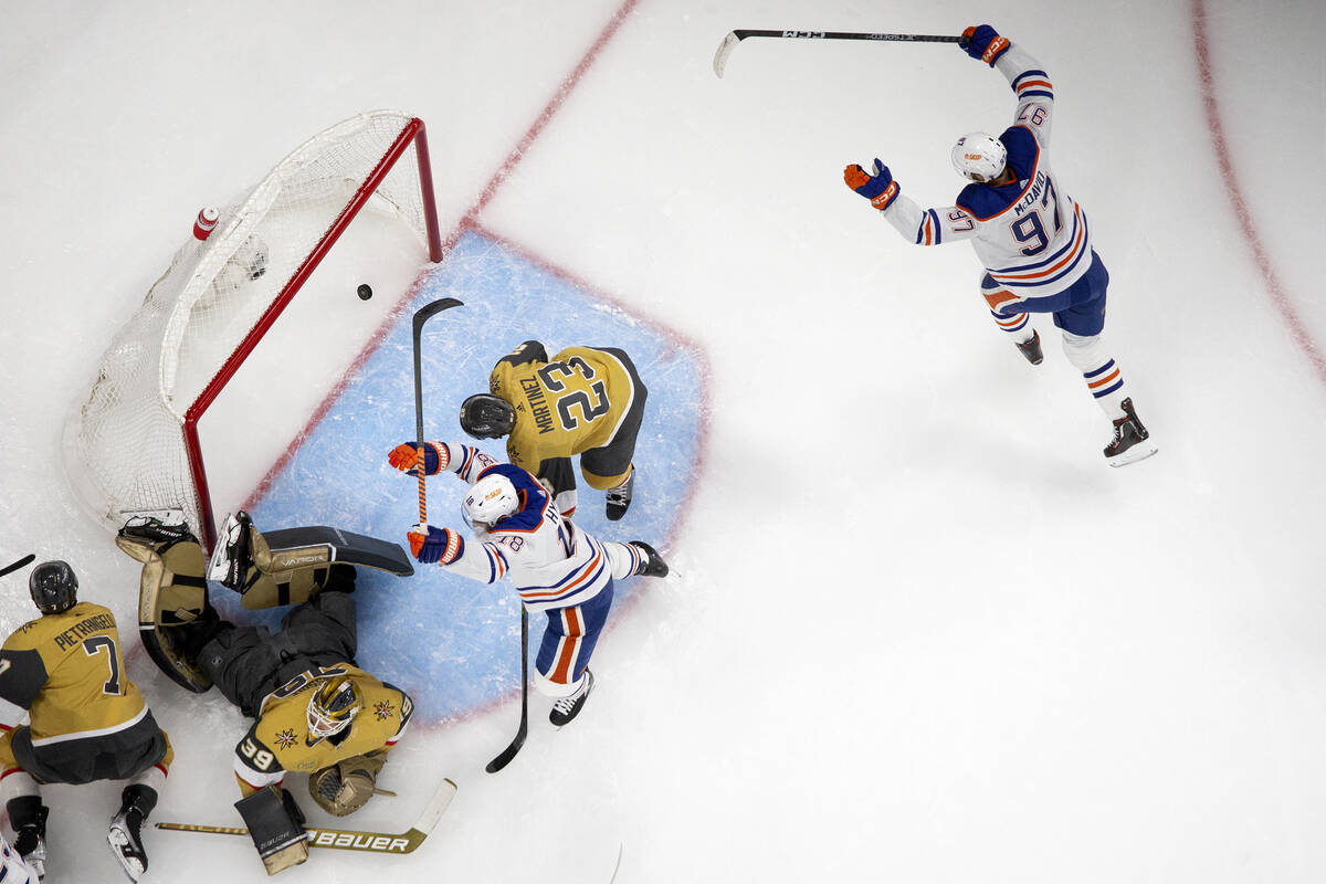 Edmonton Oilers left wing Zach Hyman (18) and center Connor McDavid (97) celebrate after their ...