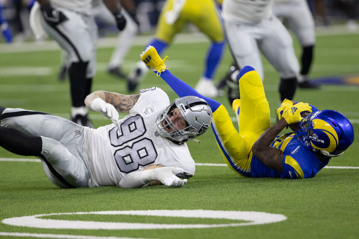Raiders defensive end Maxx Crosby (98) tackles Los Angeles Rams wide receiver Tutu Atwell (15) ...