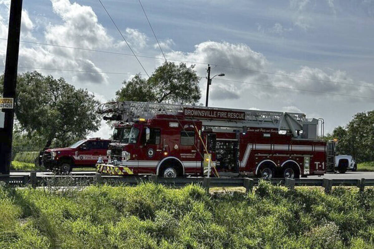 Emergency personnel work at the site of a fatal vehicular collision at a bus stop in Brownsvill ...