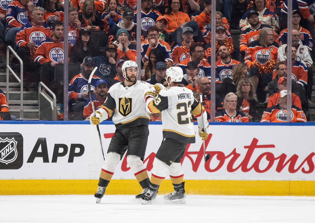Vegas Golden Knights' Nicolas Roy (10) and Alec Martinez (23) celebrate after a goal against th ...