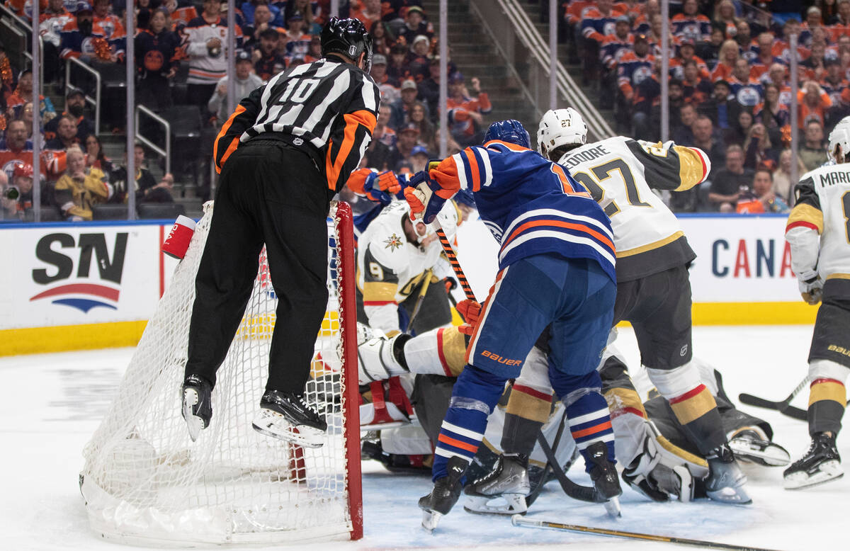 Referee Kyle Rehman tries to get a look at a play as the Vegas Golden Knights and Edmonton Oile ...