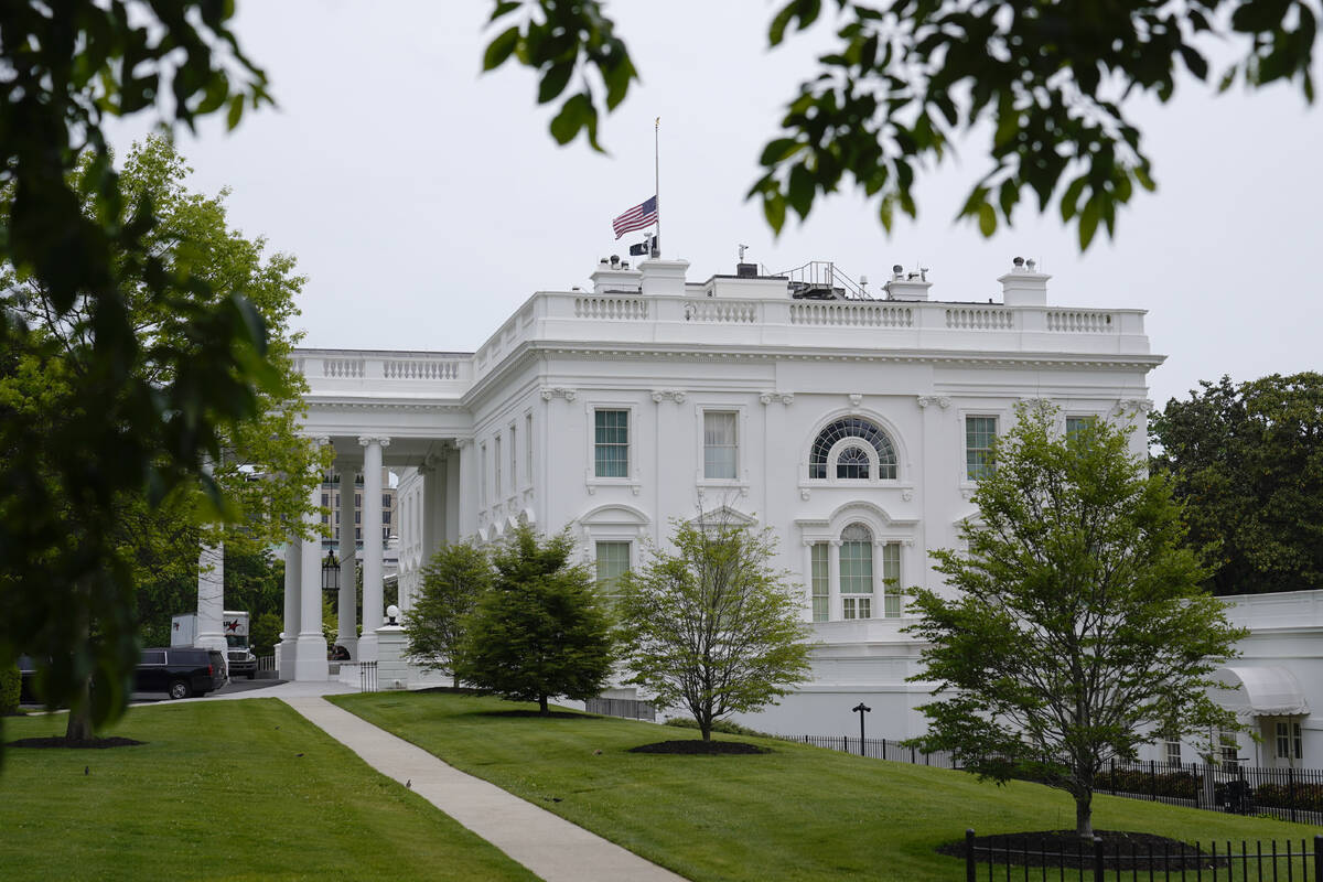 The American flag flies at half-staff at the White House in Washington, Sunday, May 7, 2023, af ...